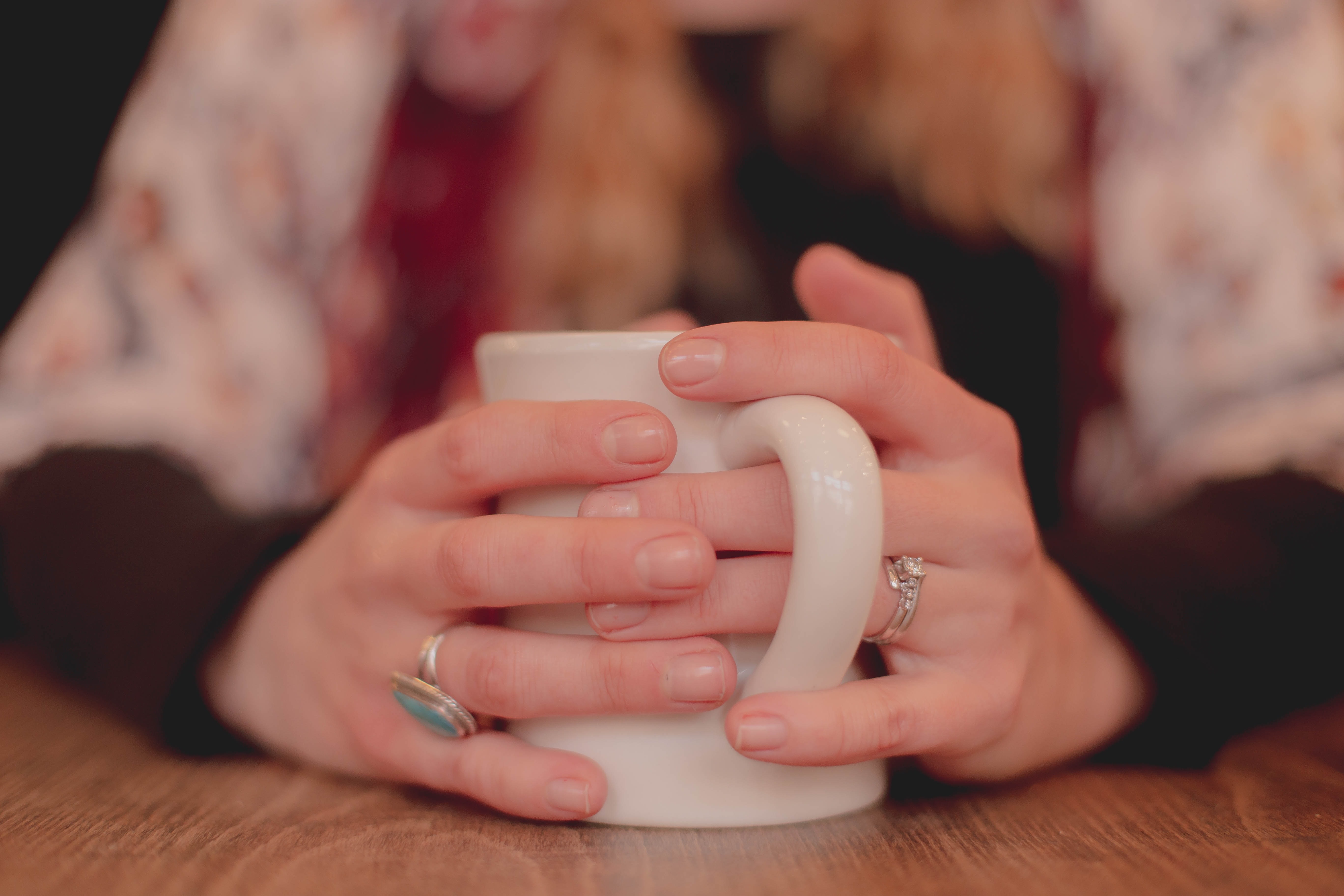 Hands around a mug of hot drink